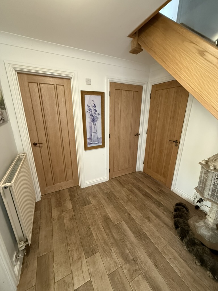 Bespoke oak door fitted with even gaps and primed frame